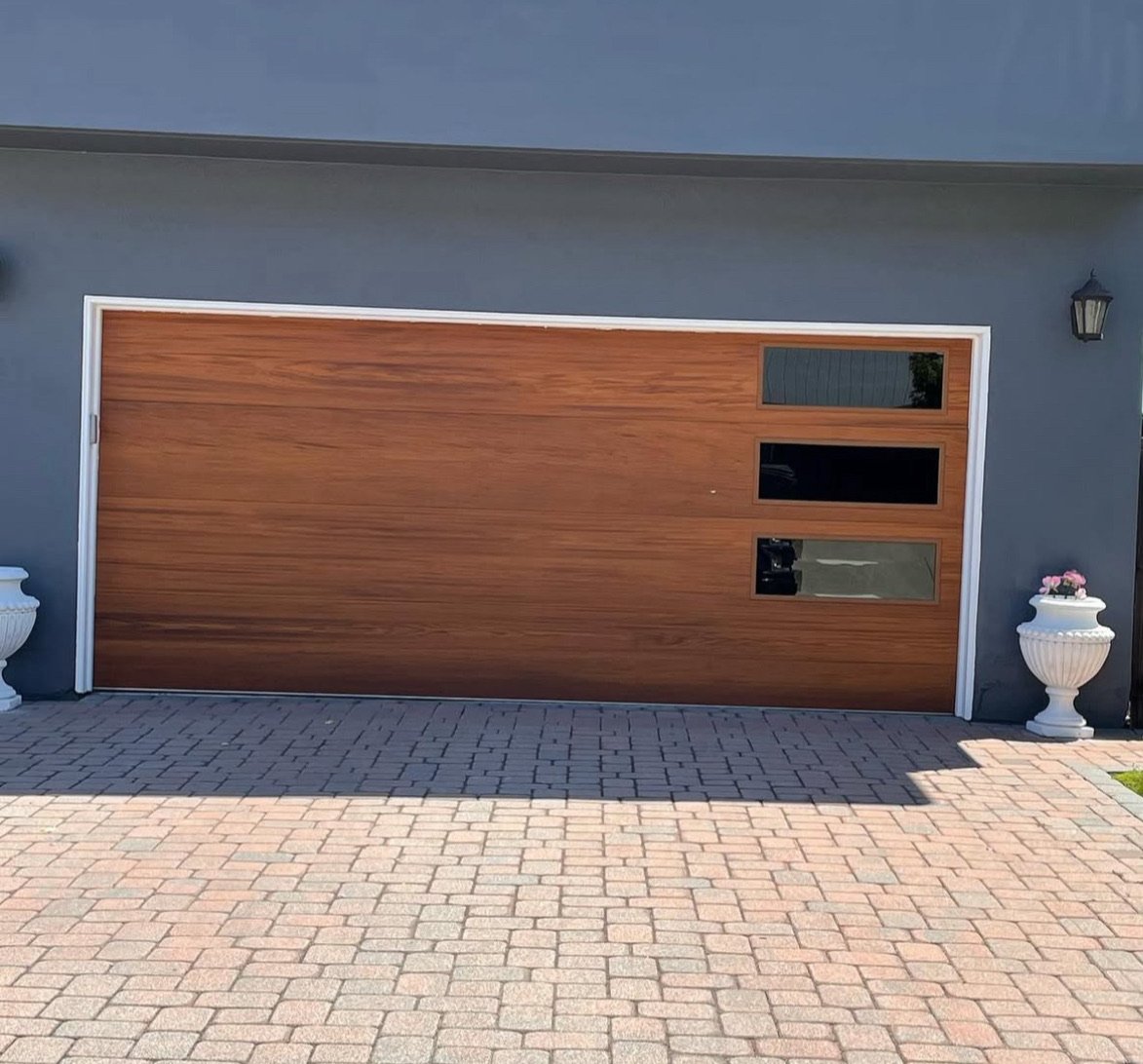Modern wood-look sectional garage door with three narrow windows