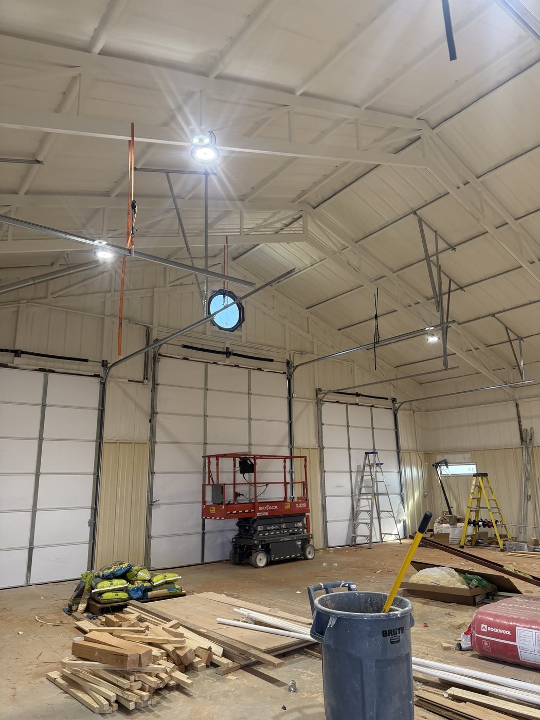 High-ceiling commercial interior with overhead door tracks