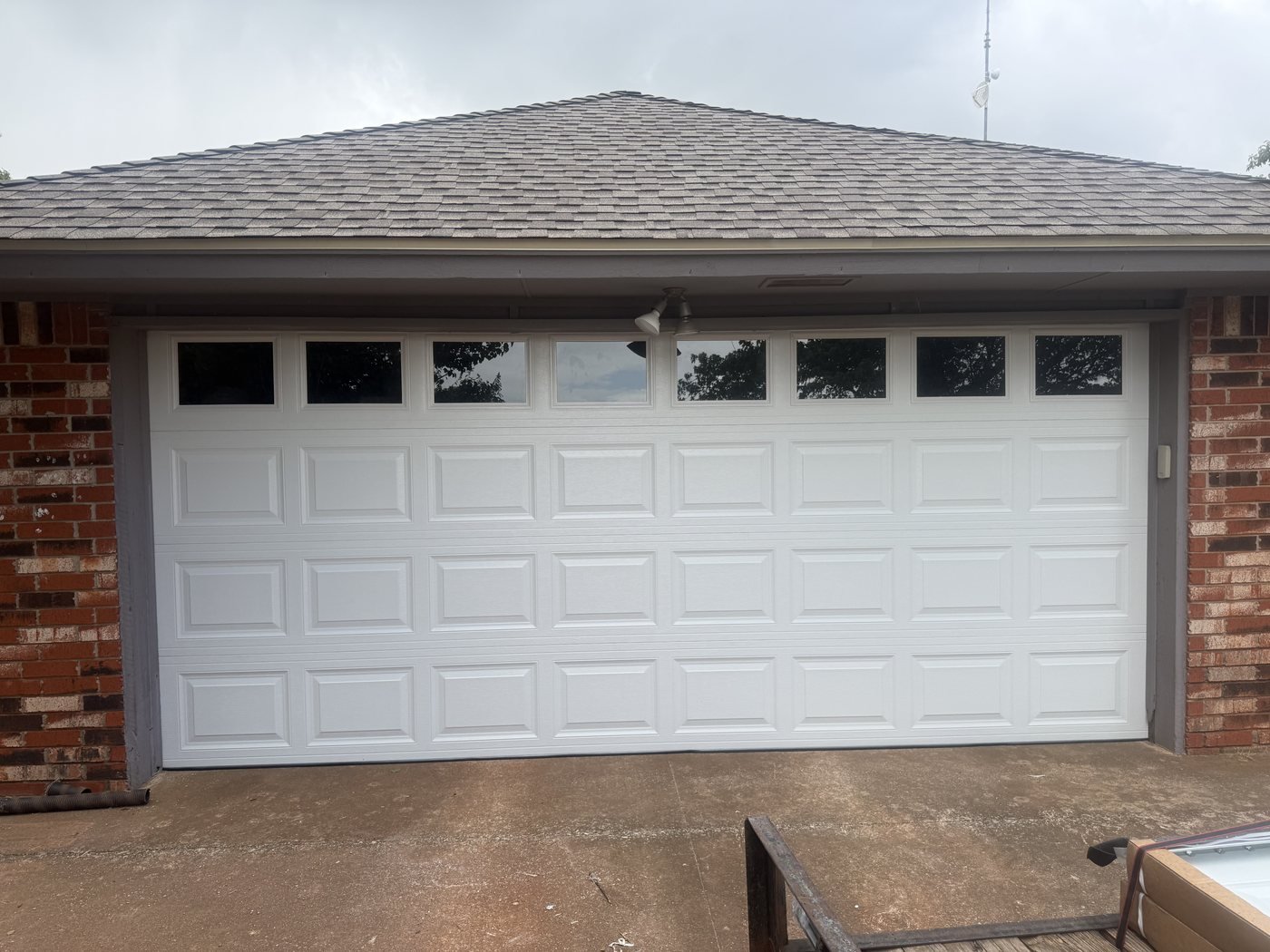 White sectional garage door with a row of top windows