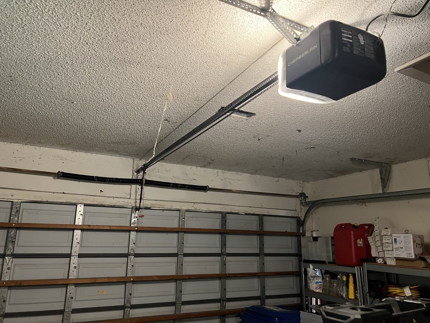 Ceiling-mounted residential garage door opener, rail and sectional door hardware